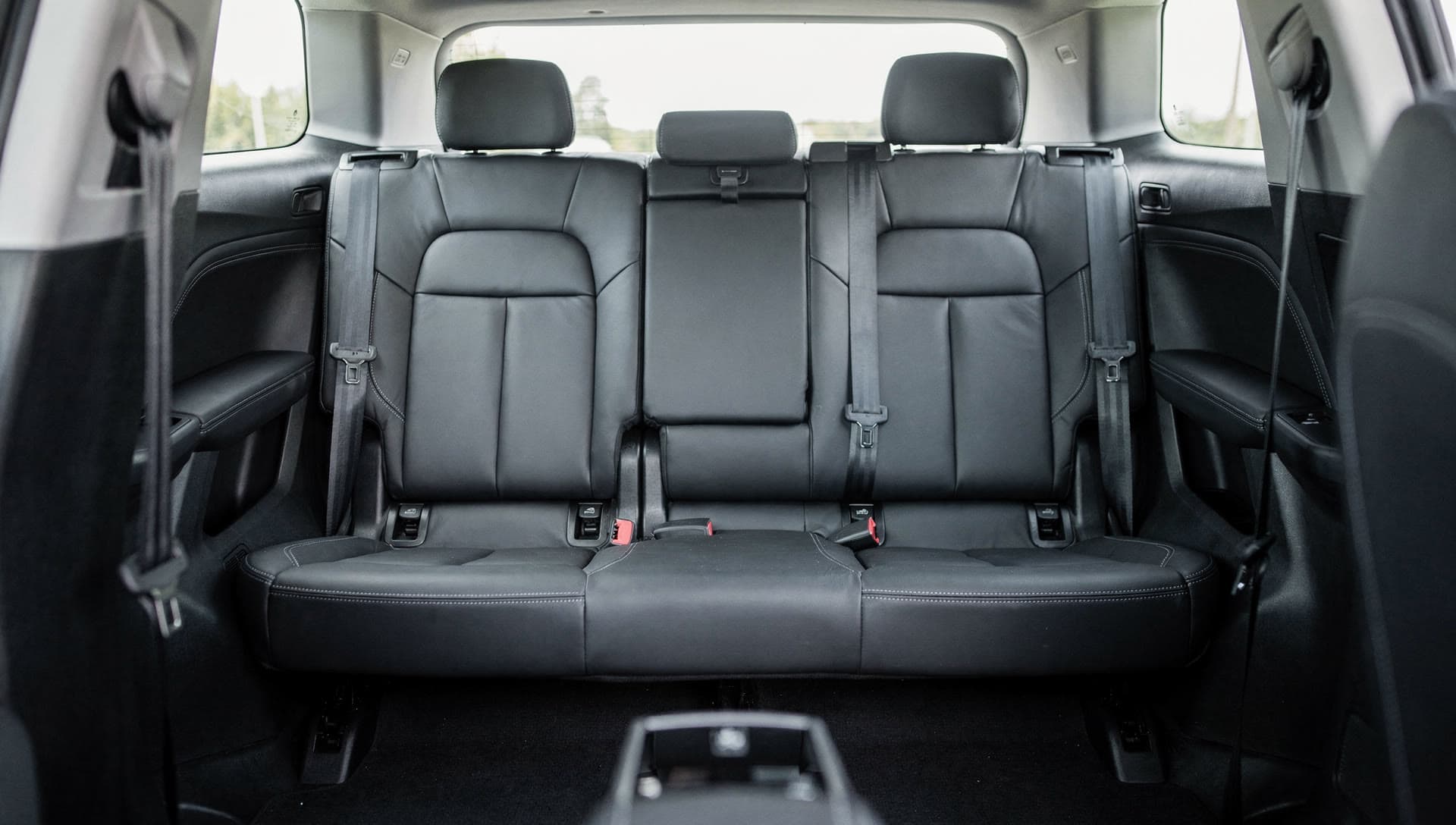 A clean, empty rear passenger cabin photographed in daylight with nothing personal left in the frame